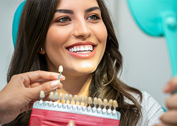 Female patient smiling after a teeth whitening treatment