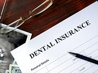 A dental insurance form marking the cost of a root canal in Jonesboro