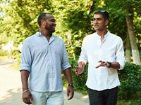 two men walking and talking with each other