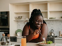 a woman eating lunch in her kitchen