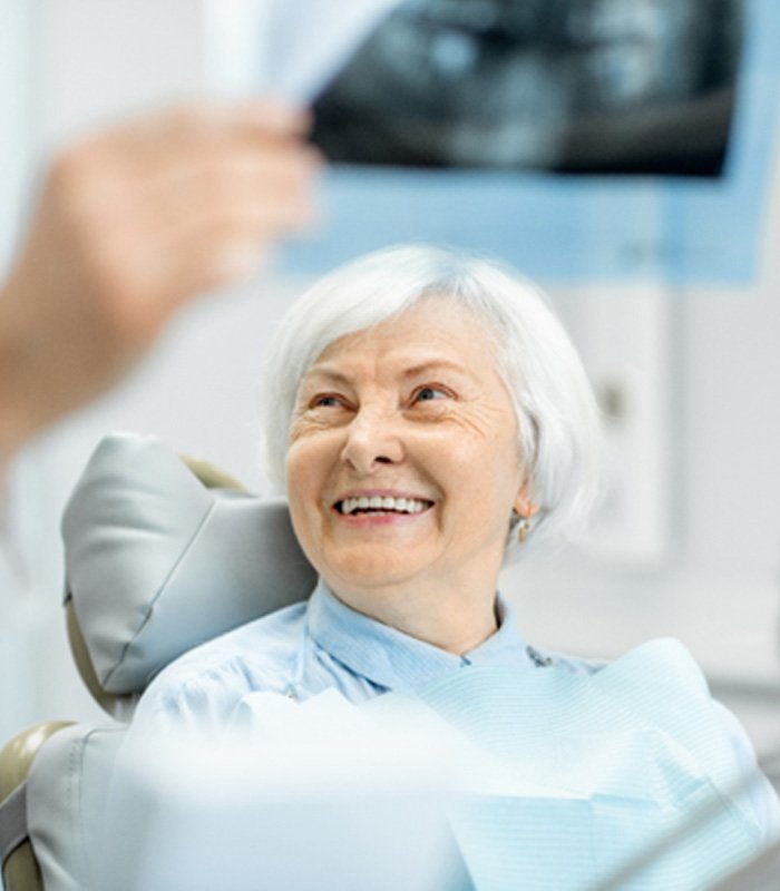 dentist explaining X-ray to older woman