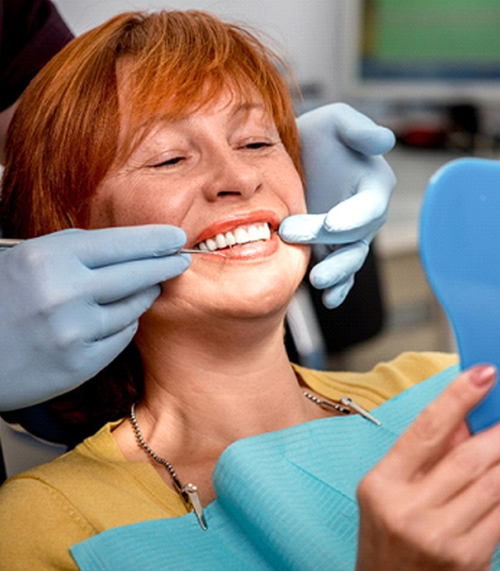 patient smiling after getting dentures in Jonesboro