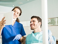 a dentist showing her patient a form