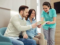patients receiving a brochure about dental insurance