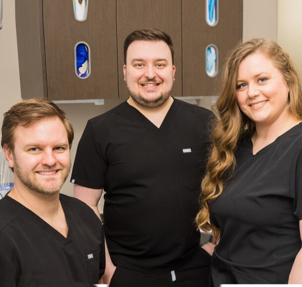 Jonesboro dentist and team members smiling in office