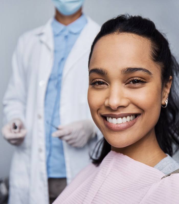 Smiling patient sitting in dental treatment chair