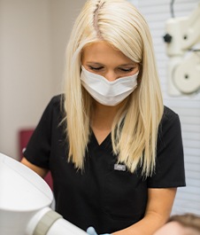 Dental team member treating patient in Jonesboro