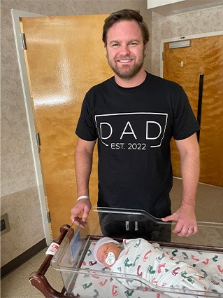 Person standing next to sleeping baby