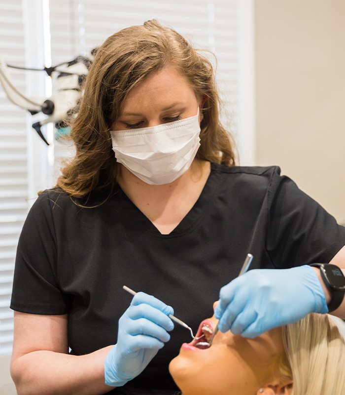 Dentist performing oral cancer screening