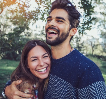 Man and woman with flawless smiles after cosmetic dentistry