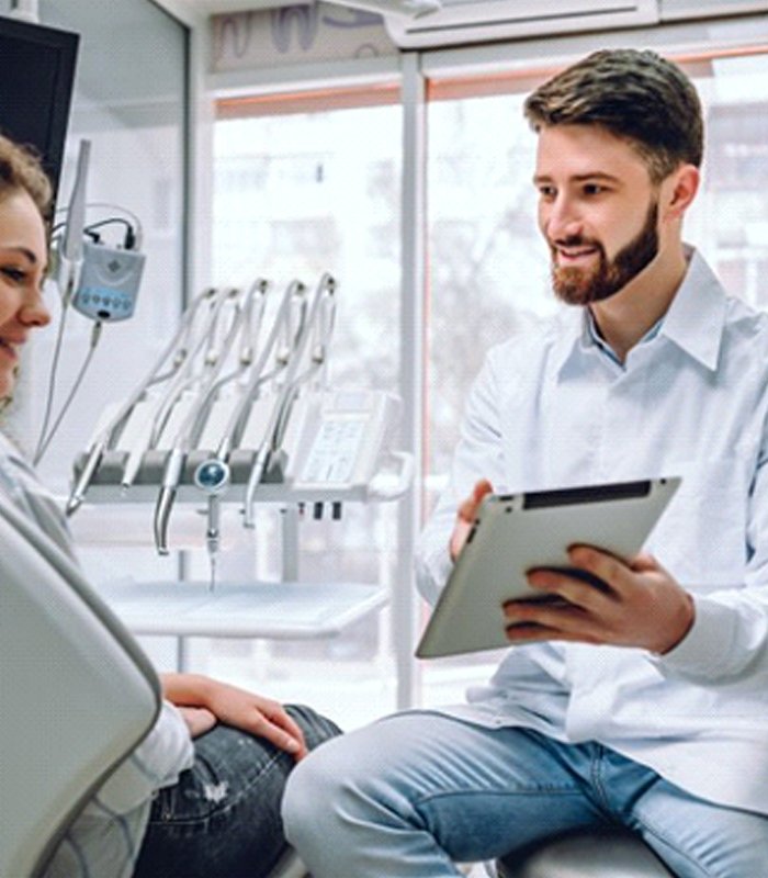 dentist showing a tablet to a patient