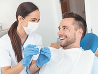 Dentist holding clear aligner and dental mold
