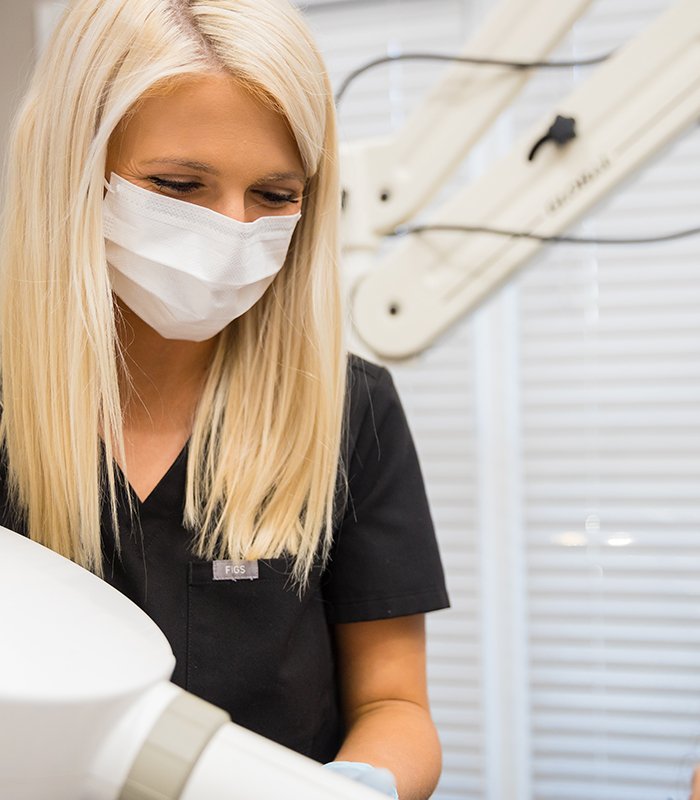 Dentist examining digital x-rays on tablet computer