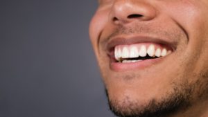 Closeup of woman pointing to her gums