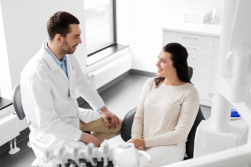 dentist talking to patient about dental implants