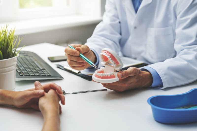 dentist explaining during dental implant consultation