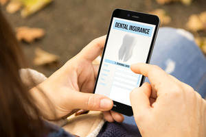 Looking at dental insurance form on phone