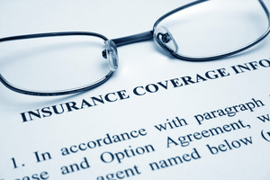Glasses on a piece of paper titled “Insurance Coverage Information”